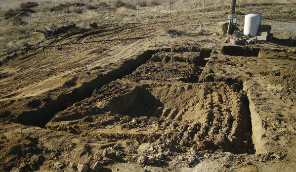 Rough Trenching Complete
A day's work is done.  The site is graded and the footings are dug.  The large hole in the middle foreground is for the pier base, to be 16" deep and 7' by 4'
